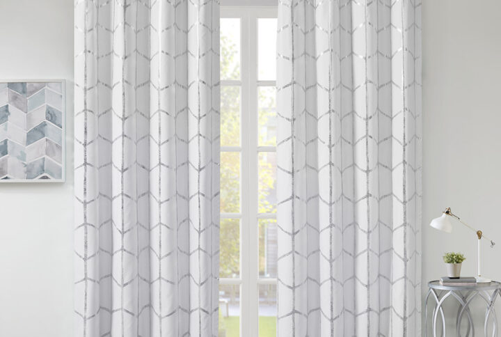 Raina Total Blackout Metallic Print Grommet Top Curtain Panel in White/Silver From Intelligent Design